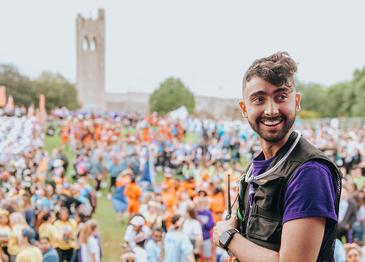 Student looking back in front of a crowd