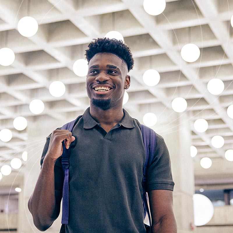 male student walking through weldon library